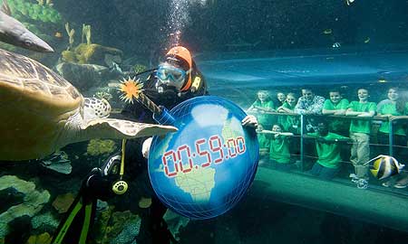 Pictured with naturalist and broadcaster Nick Baker as a diver carries a symbolic ‘time-bomb’ earth through the ocean tank at the National Sea Life Centre, are from left to right: Standing - Tierney Carter, Rebecca Johnson, Amber Rowland (Nick Baker), Ricky Froud, Matthew Newsome and Abigale Rudland. Kneeling - Molly Clayton, Hannah Layton and Kwabe Tenkorang.