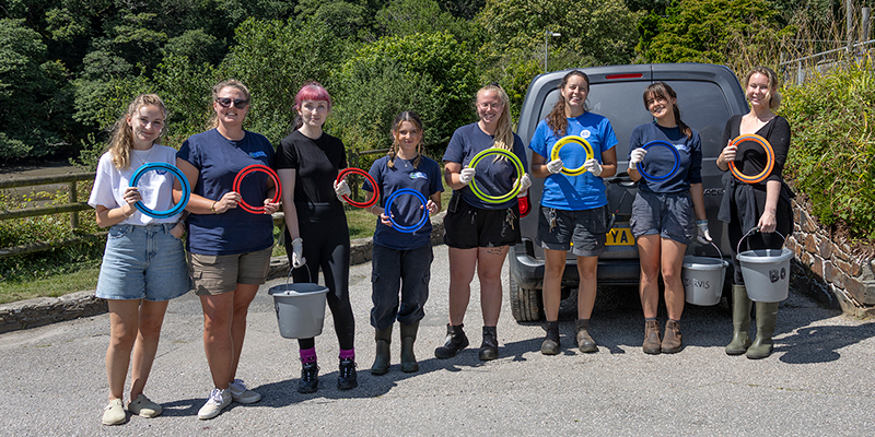 Some of the animal care team holding flying rings